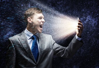 Aggressive businessman screaming fiercely in mobile phone